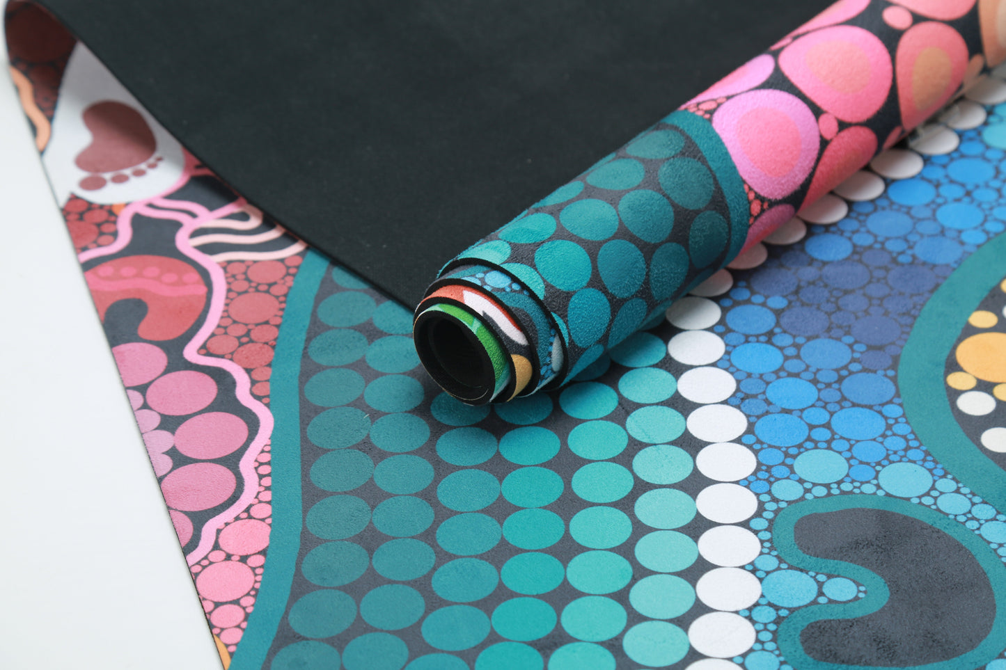 A Breath of Fresh Air Indigenous Yoga Mat in use, displaying the sacred Aboriginal design with traditional symbols of wind, breath, and life force that create a spiritual foundation for yoga practice and connection to country