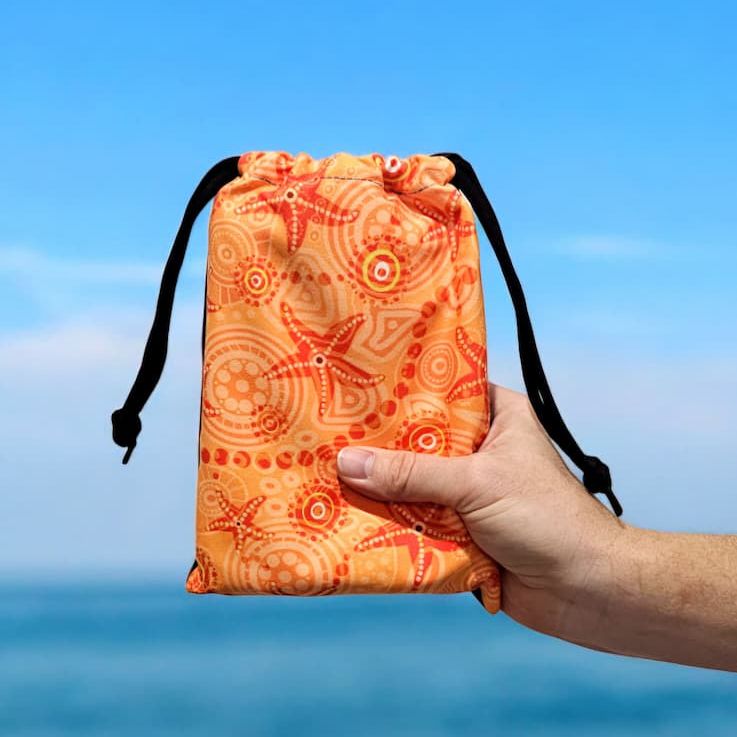 Design layout of Starfish Kids Indigenous artwork featuring traditional Aboriginal starfish symbols, ocean dot work patterns, and cultural motifs in vibrant orange that celebrate children's connection to sea life and coastal country traditions