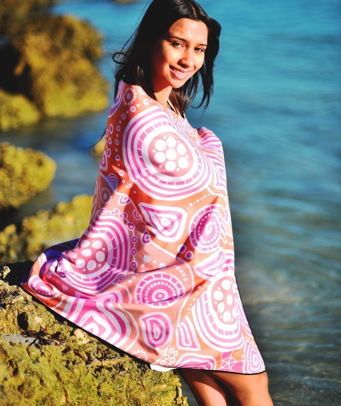 Detailed view of Walkabout Indigenous Beach Towel featuring traditional Aboriginal walkabout symbols, journey patterns, and cultural motifs in orange that represent the sacred act of walking country and spiritual connection to ancestral pathways