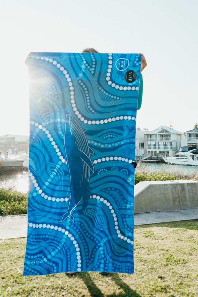 Blue towel with wave design held by a person outdoors